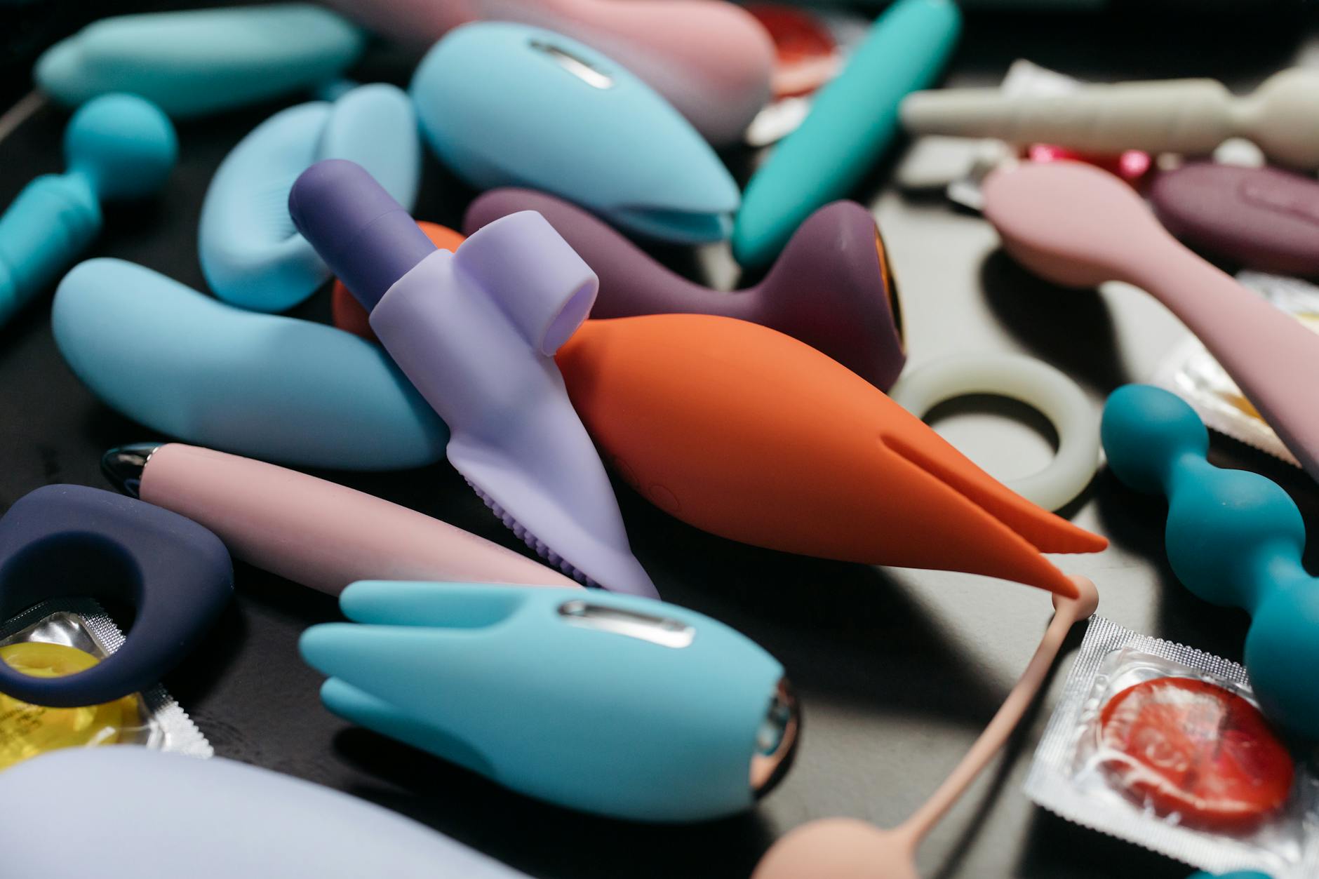 An array of vibrant adult toys including lemon clitoral vibrators in a close-up view
